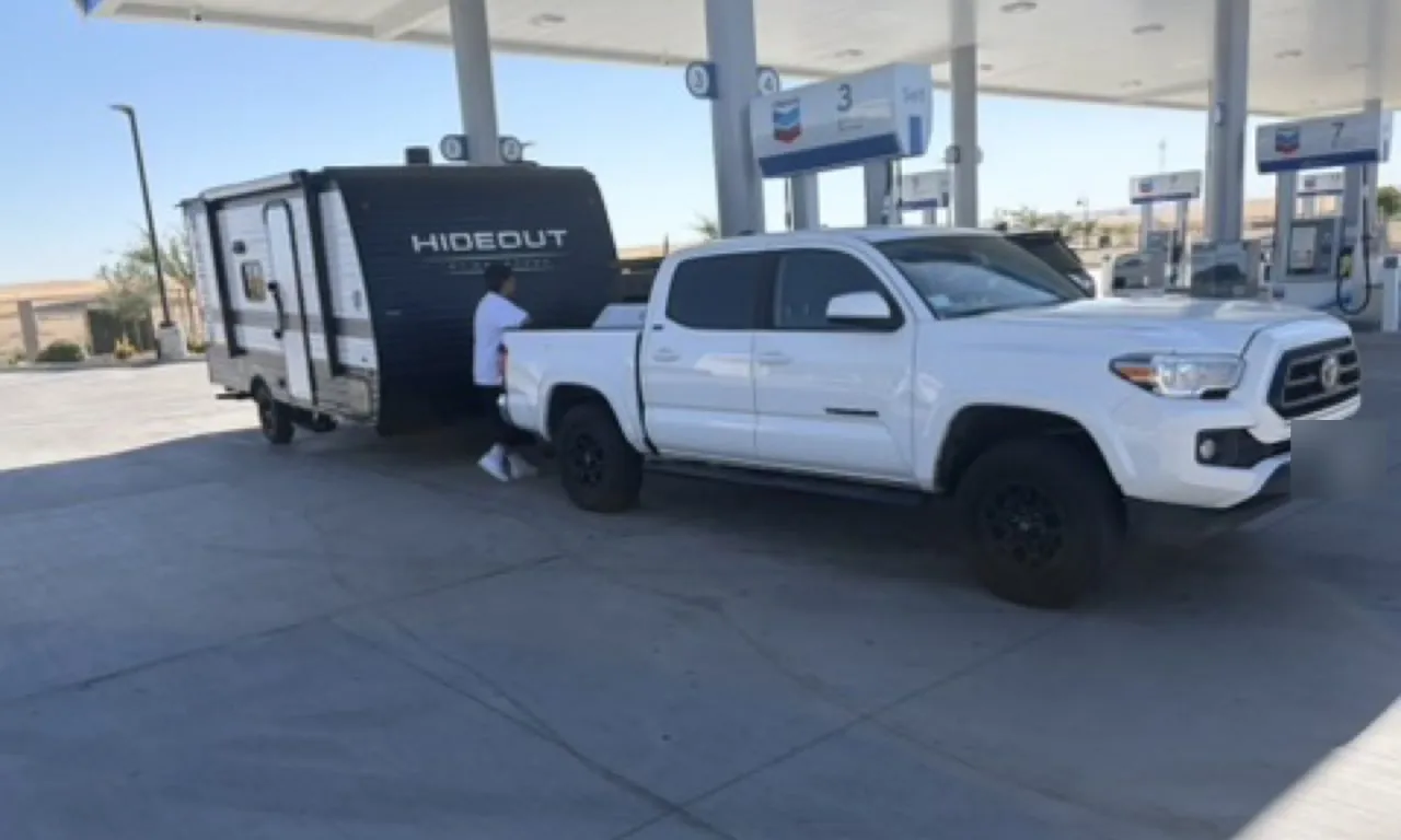 A pickup truck on a lift in a dealership service bay